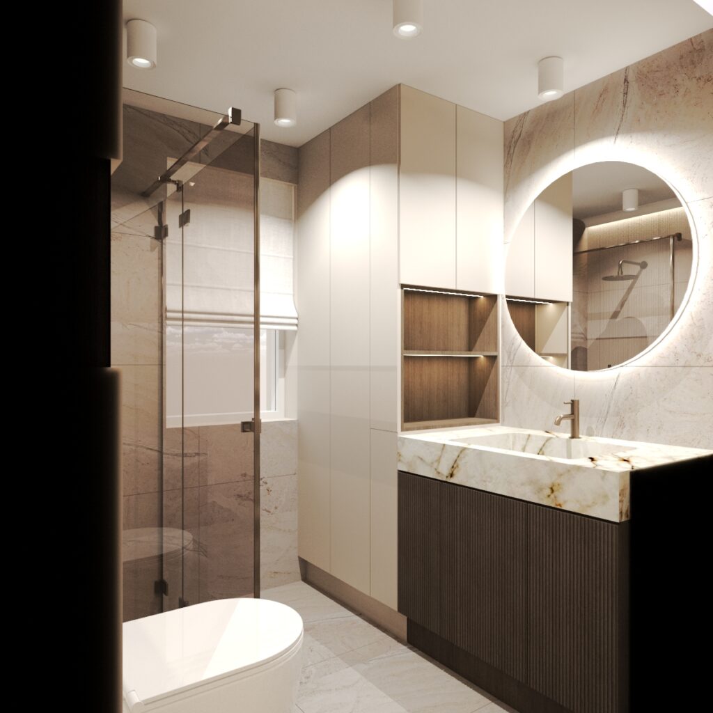 Nowoczesna łazienka z marmurowymi ścianami, okrągłym podświetlanym lustrem i ciemnoszarą szafką podumywalkową z ryflowanym frontem. Po lewej stronie znajduje się kabina prysznicowa ze szklanymi drzwiami, a nad nią wysokie szafki ścienne w jasnych kolorach.